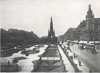 Black and white photo of a busy Princes Street with trams, pedestrians, and The Scott Monument at the center.